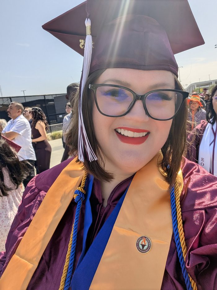 Cara at her Mt. SAC graduation in cap and gown, smiling